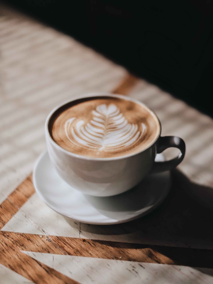 Filiżanka latte z rozetą na drewnianym blacie